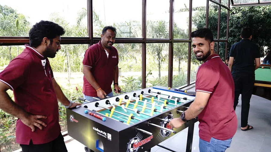 three_people_playing_foosball_at_Ravishing_Retreat_during_daytime three_people_playing_foosball_at_Ravishing_Retreat_during_daytime